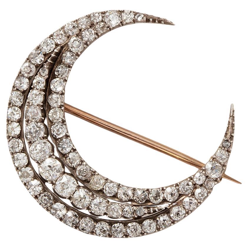 A Gold and Silver Crescent Brooch with Diamonds