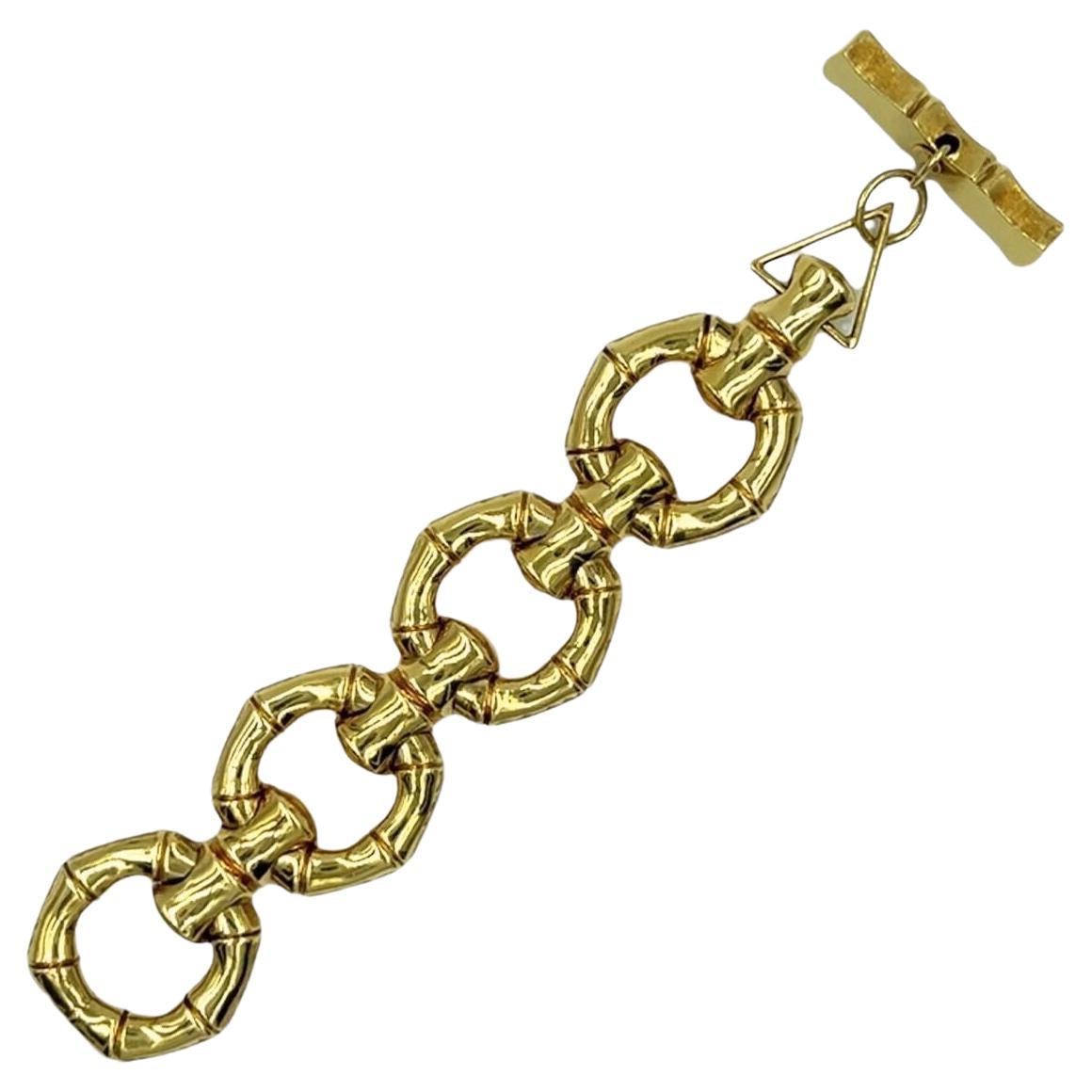 An 18 karat yellow gold bracelet, Italy.  Fashioned as a bold row of bamboo motif links completed by a toggle clasp.  Length approximately 7 inches.  Gross weight approximately 95.50 grams.