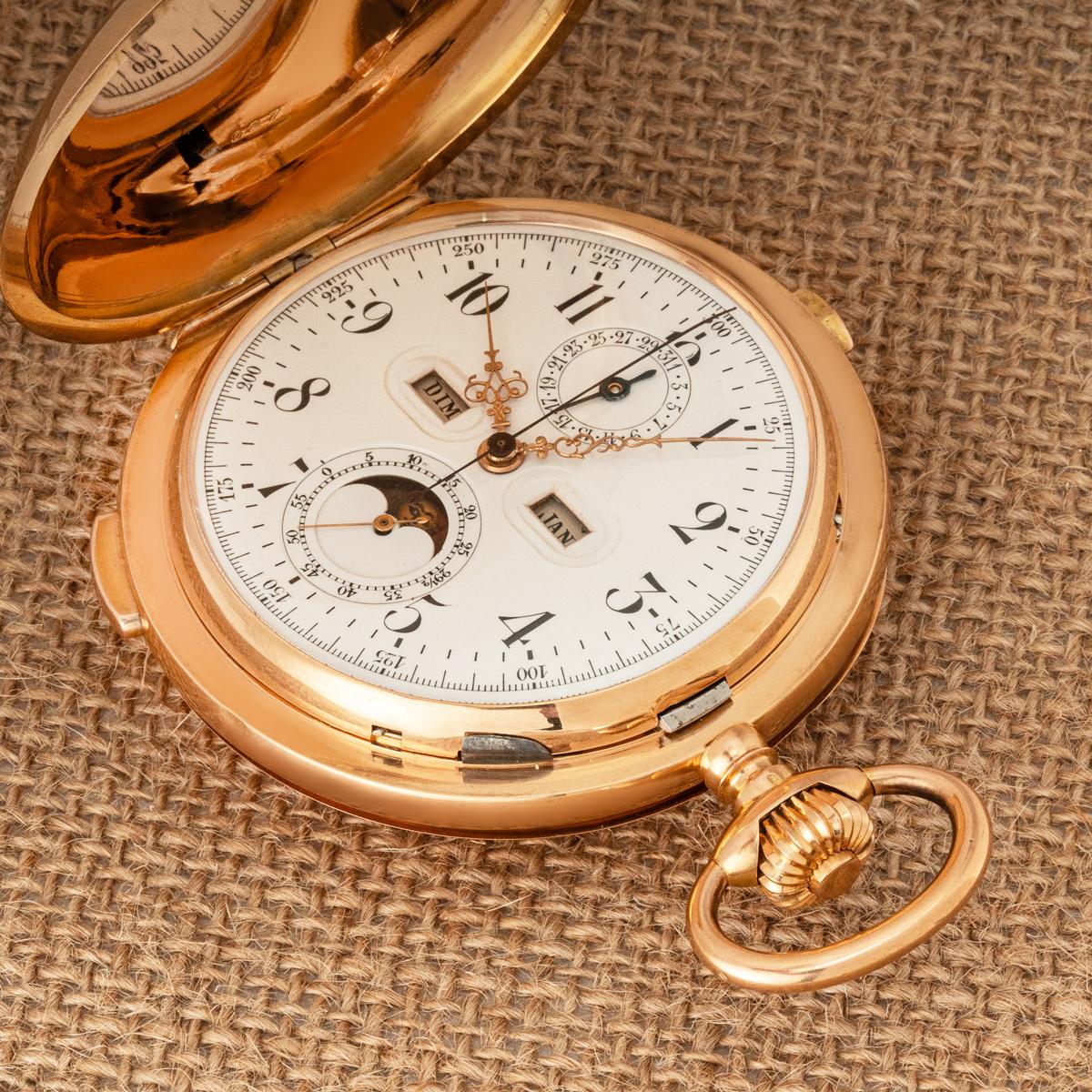 A Gold Full Hunter Keyless Lever Calendar Quarter Repeater Chronograph Pocket Watch C1890

Dial: A perfect white enamel dial with Arabic numerals and outer tachymetric scale. The dial has a window at nine o'clock for the day and a window at three