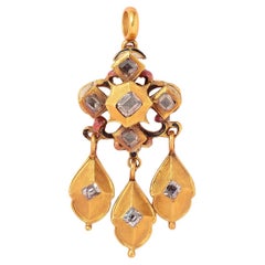 a gold girandole pendant with diamond