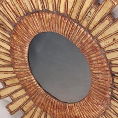 A Gold Glass and Resin Sunburst Mirror.