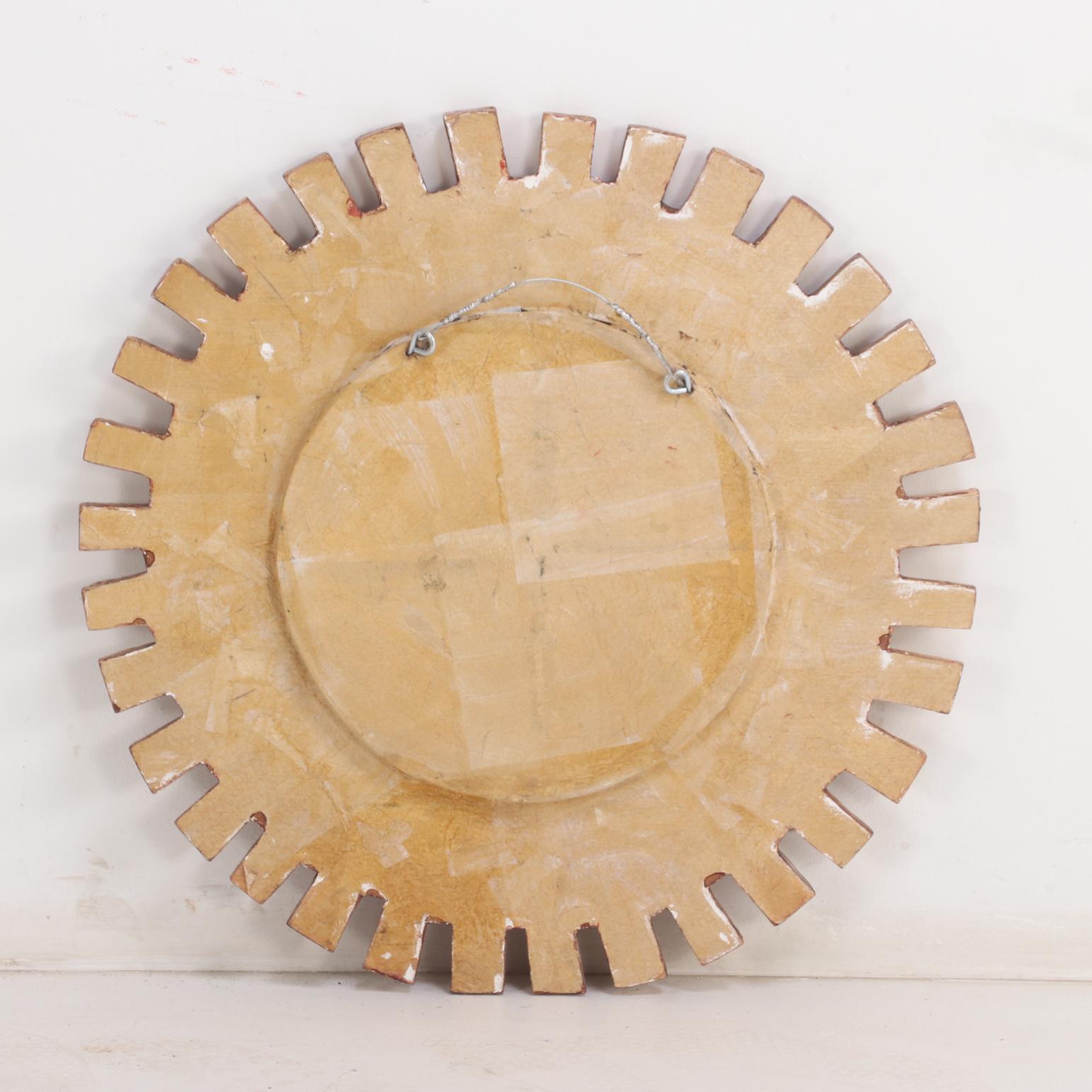 Argentine A Gold Glass and Resin Sunburst Mirror. For Sale
