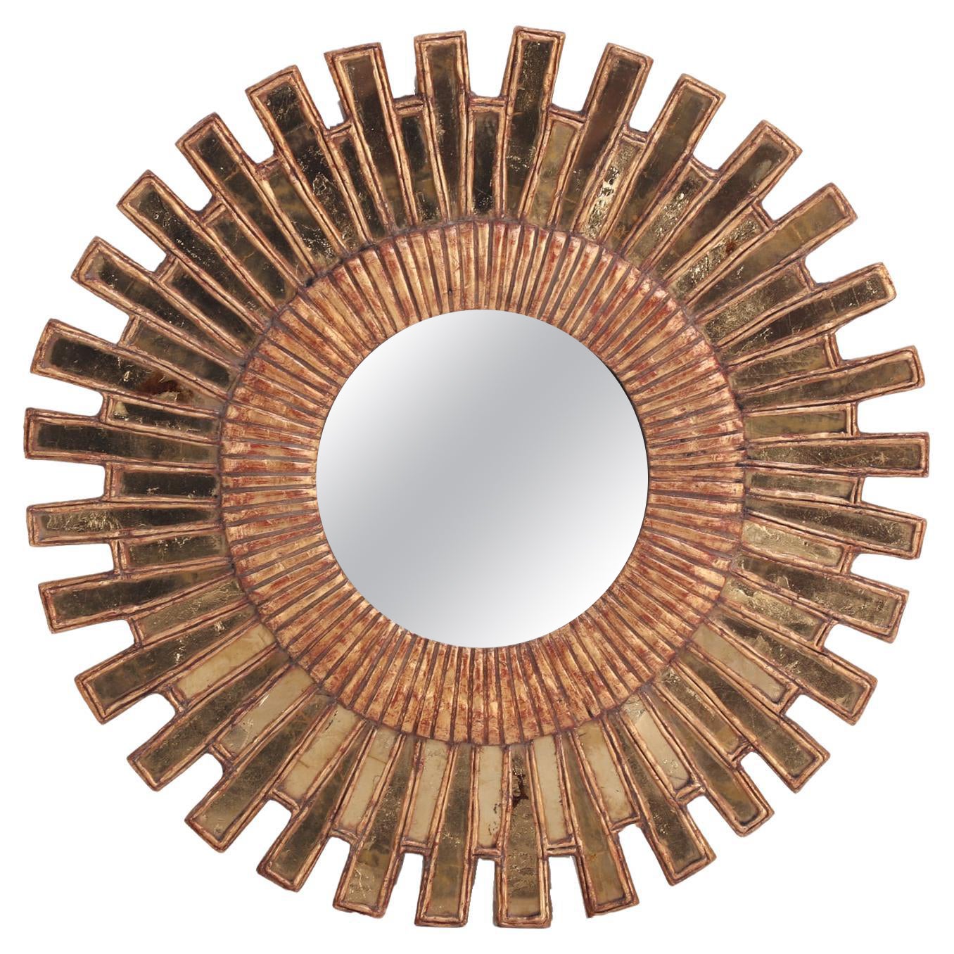 A Gold Glass and Resin Sunburst Mirror. For Sale