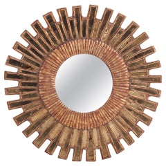 A Gold Glass and Resin Sunburst Mirror.