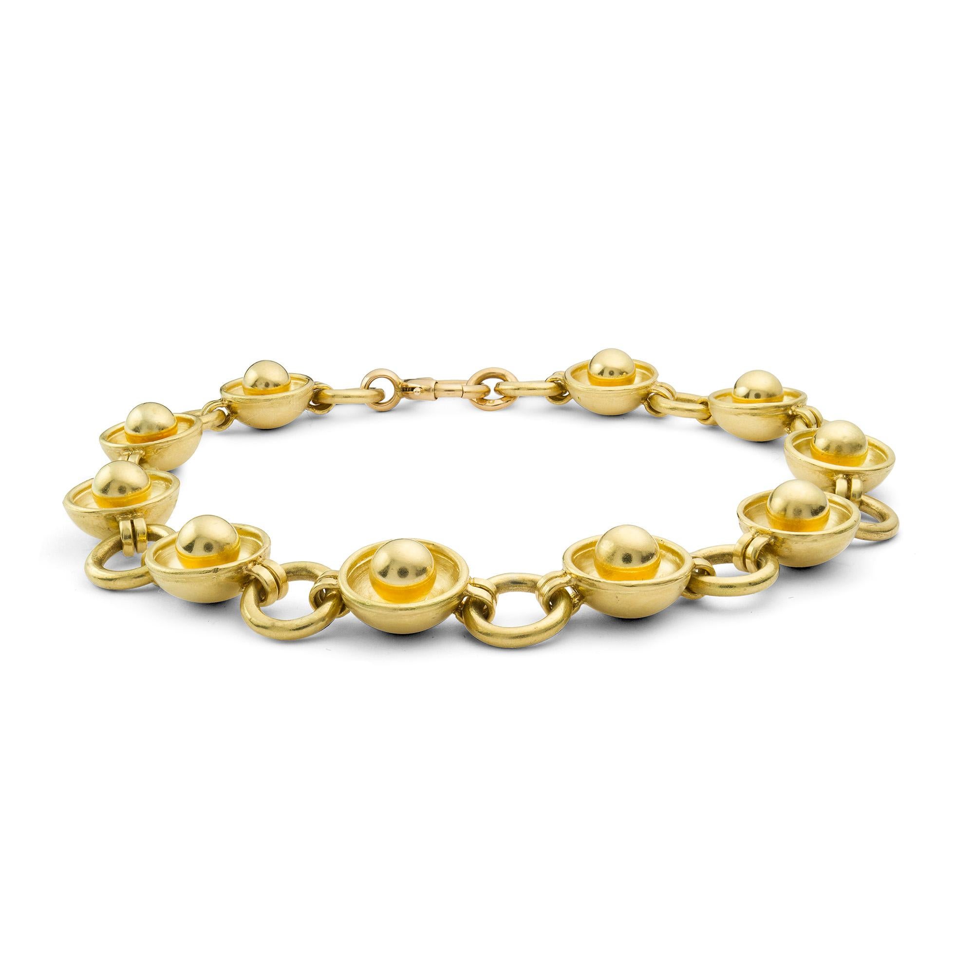 A gold link bracelet, designed as circular gold cups with centre gold ball link alternating to an open ring link, all in 18ct yellow gold, hallmarked 18ct gold, London 2015, made by Bentley and Skinner sponsor mark, measuring approximately 23cm in