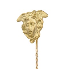 A gold Medusa stick pin made by Bentley & Skinner