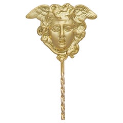 A gold Medusa stick pin made by Bentley & Skinner