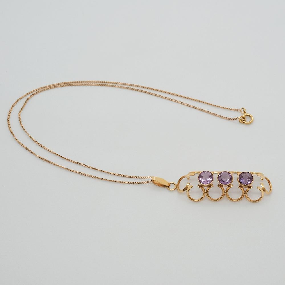 This necklace and pendant are made out of 14 karat gold and three amethysts. The three amethysts have a light purple color and they are surrounded by golden arches.

The necklace is perfect for any social event as well as for the everyday wardrobe. 