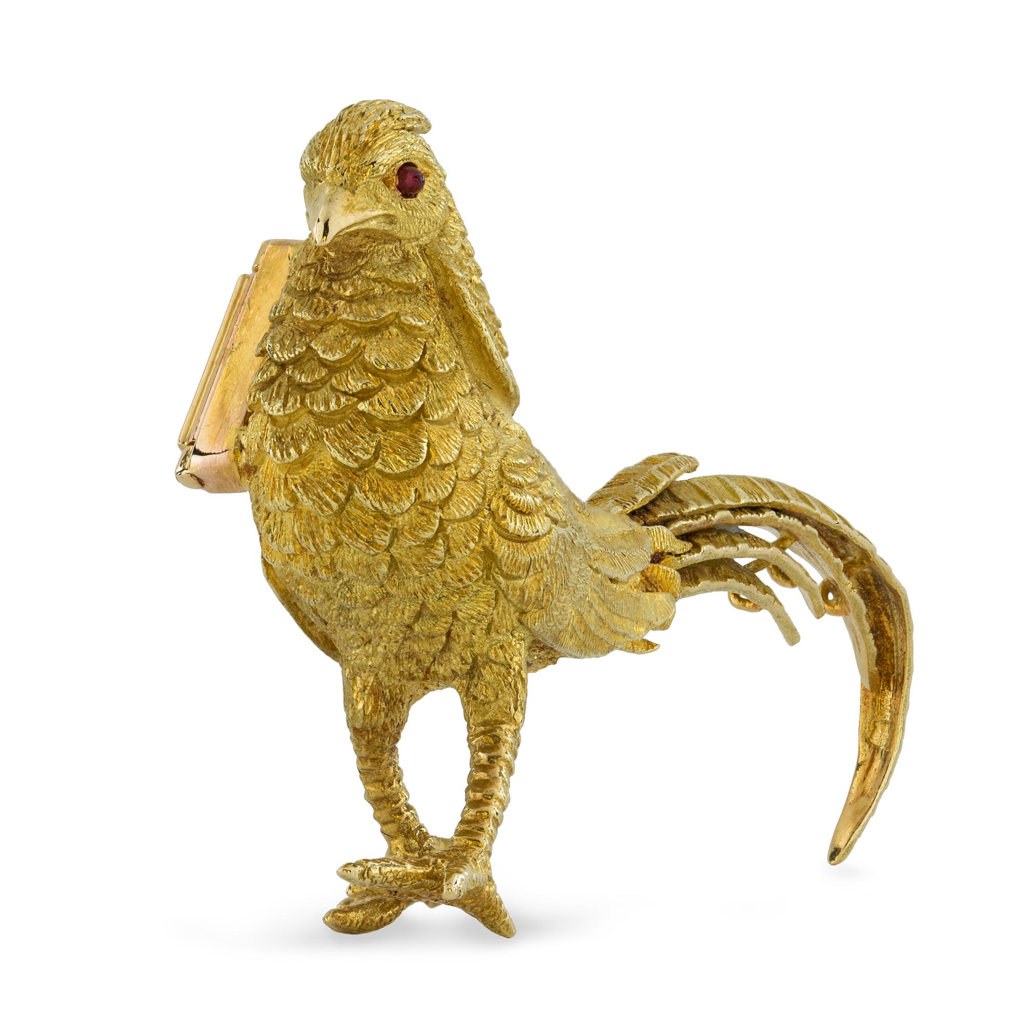 A gold pheasant brooch, with realistically carved body set with faceted ruby eyes, bearing French marks for 18ct gold, circa 1960, measuring approximately 5.9 x 3.1cm, gross weight 19.6 grams.

This estate sourced brooch is in very good