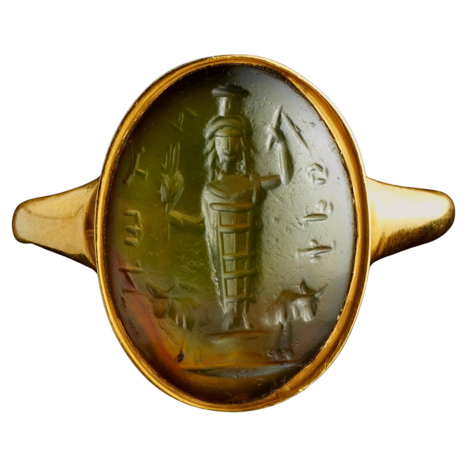 A gold Ring set with a Roman Magical Prasium Intaglio. Jupiter Heliopolitanus.