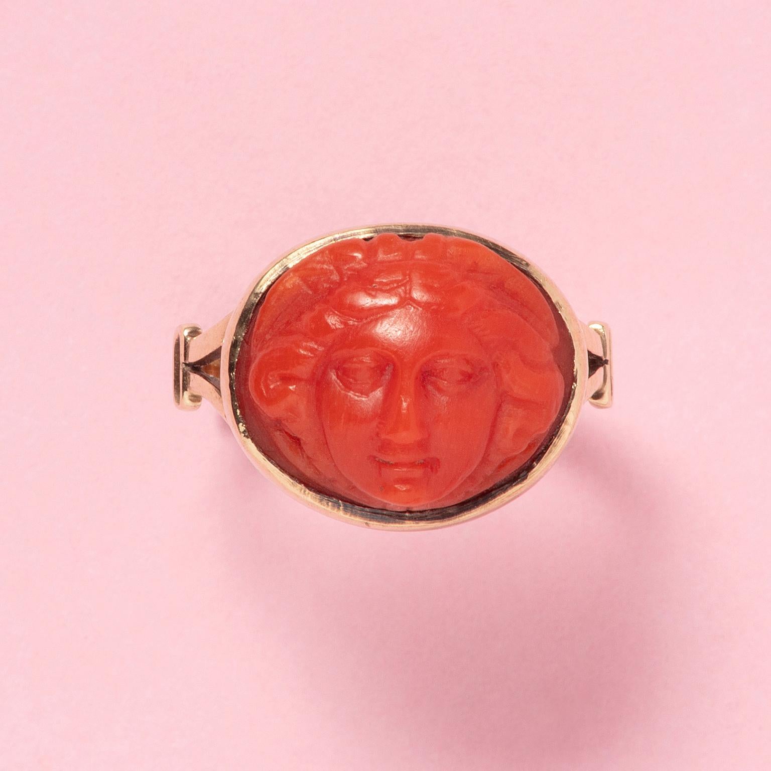 A 14 carat yellow gold ring set with a coral cameo of Medusa, marked with French import marks

weight: 3.82 g
size: 17 mm / 6 3/4 US
dimensions: 1.2 x 1.5 cm