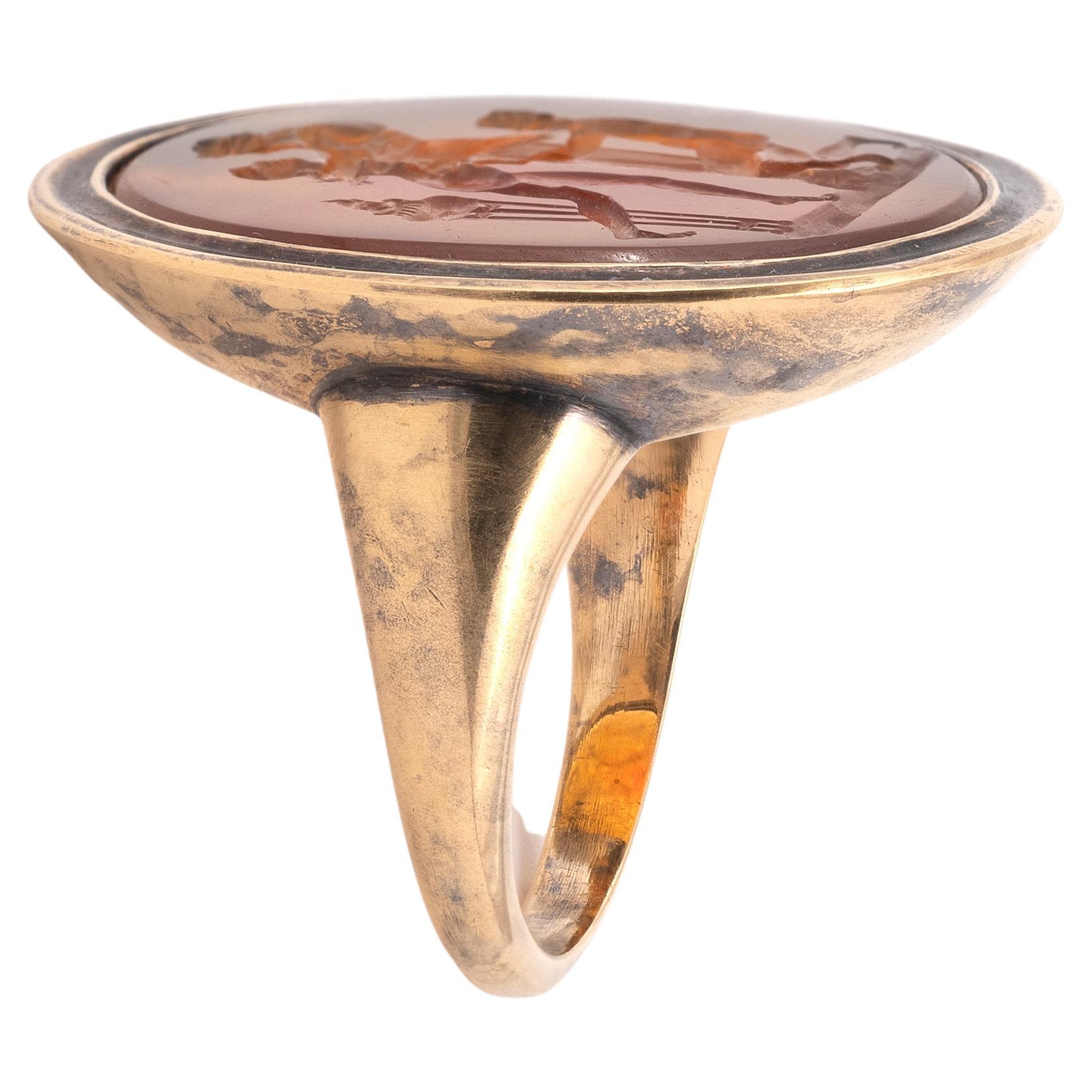 A finger ring with a cornelian intaglio depicting a scene of sacrifice to Priapus.
Size: 7
Weight: 13gr.
