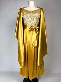 A Gold satin ball gown embroidered by Norman Hartnell – England Circa 1965