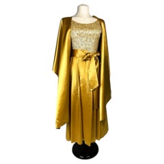 A Gold satin ball gown embroidered by Norman Hartnell – England Circa 1965