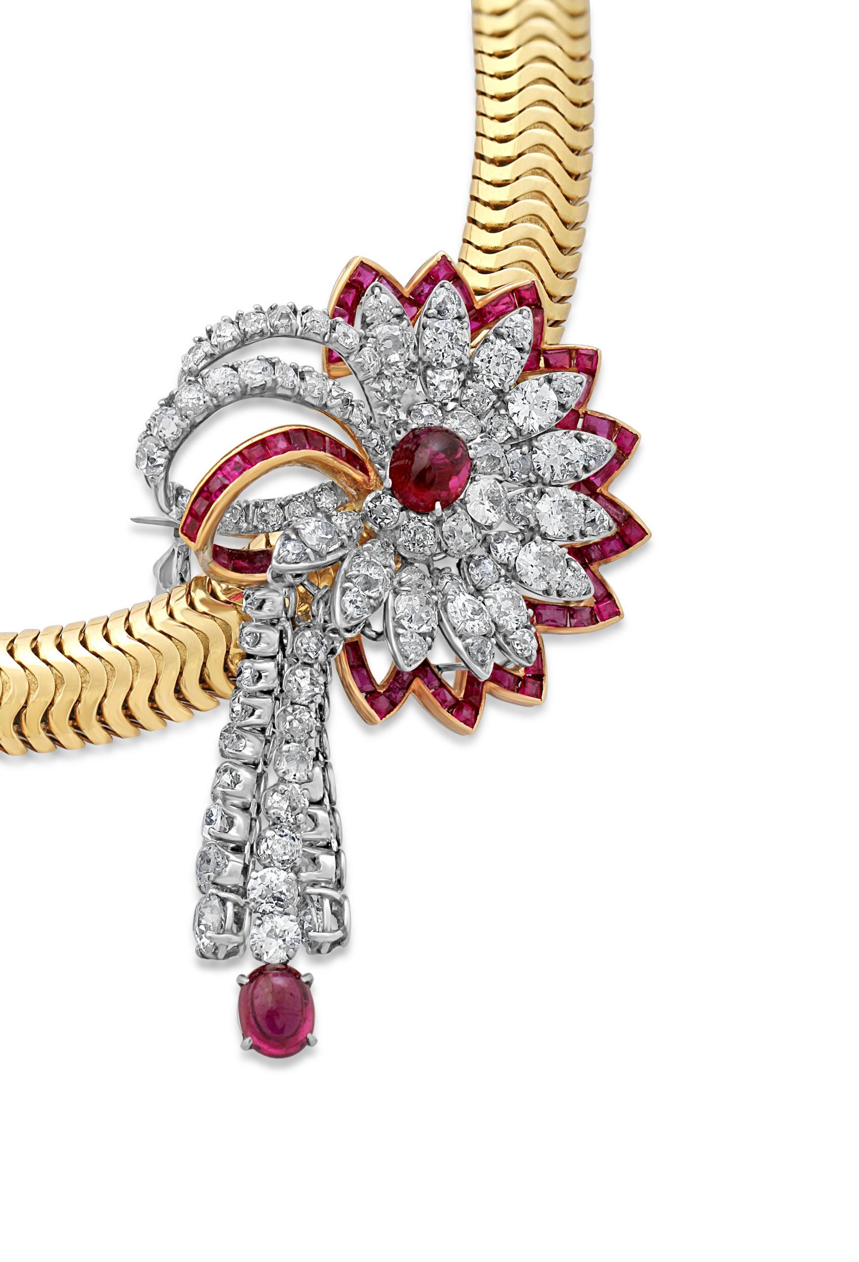 An 18k gold tubogas necklace with a detachable brooch fitting. The brooch is crafted from platinum and set with diamonds and cabochon rubies in a floral design. Circa 1940s.