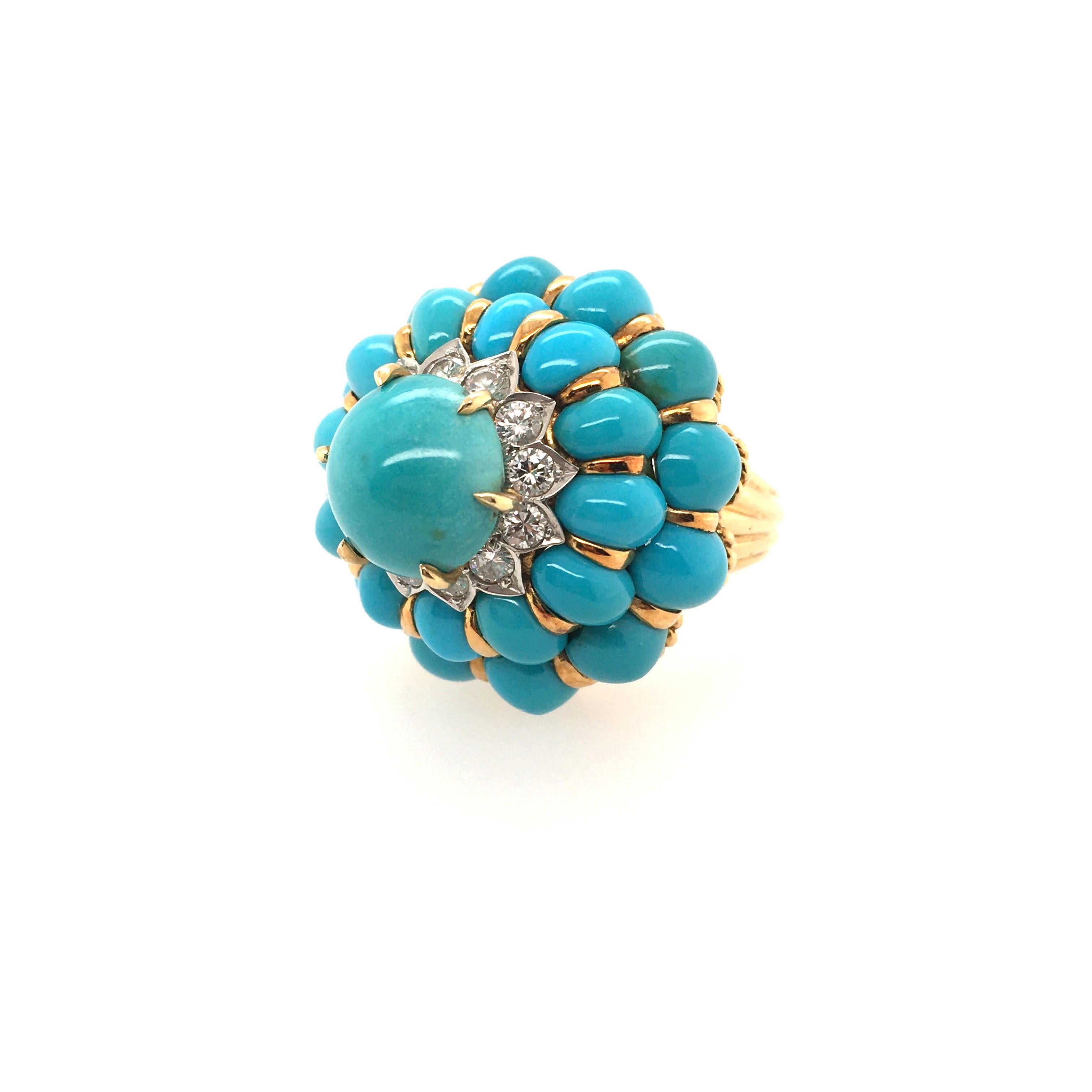 An 18 karat yellow gold, turquoise and diamond ring. Circa 1960. Designed as a dome, set with oval cabochon turquoise, centering a round cabochon turquoise, measuring approximately 10.5mm, enhanced by circular cut diamond detail. Size 8, gross