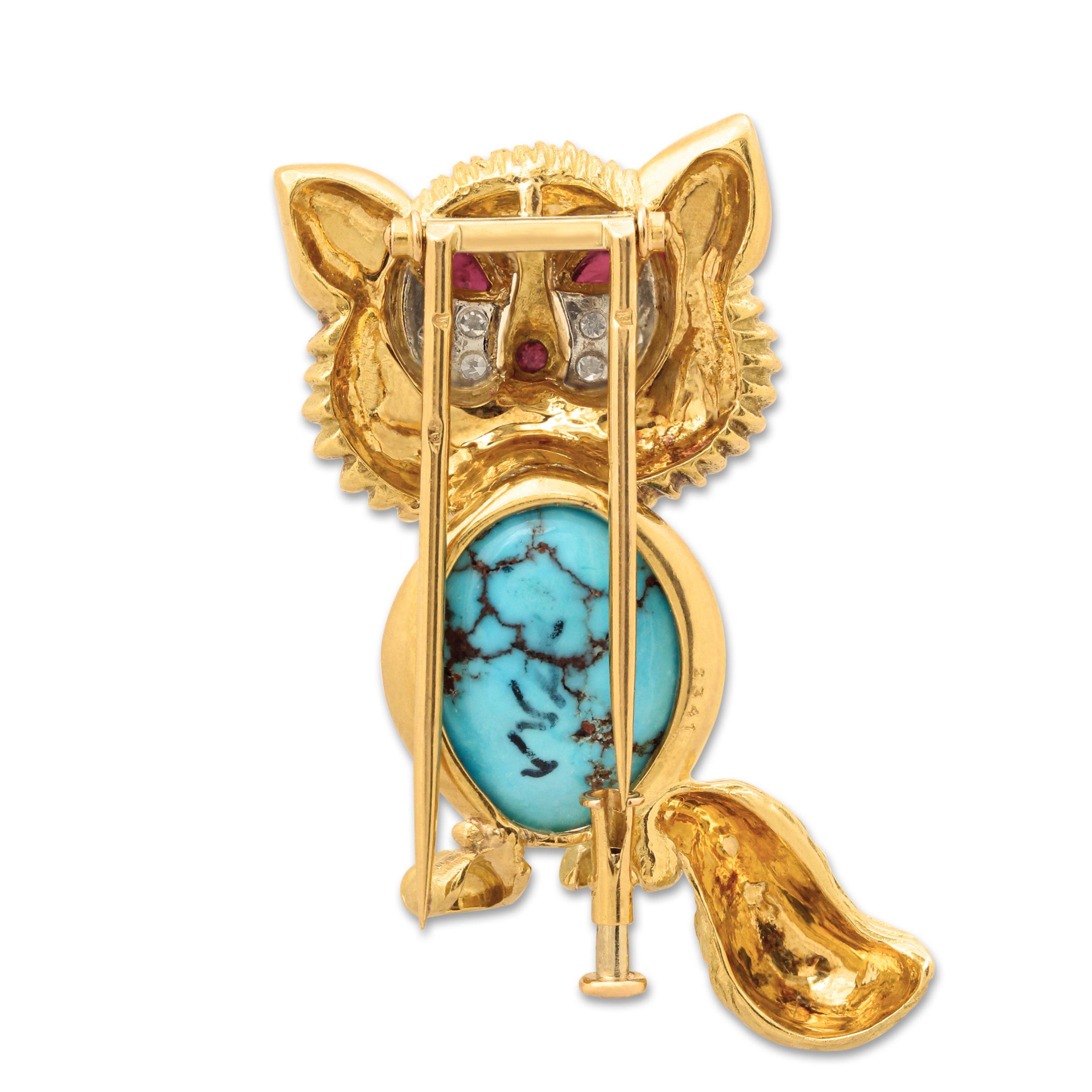 A mid-century gold and gem set cat brooch by Cartier. This charming multi gem creation is set at the centre with a vibrant cabochon turquoise and ruby eyes surrounded by diamonds all set in textured 18k yellow gold. 