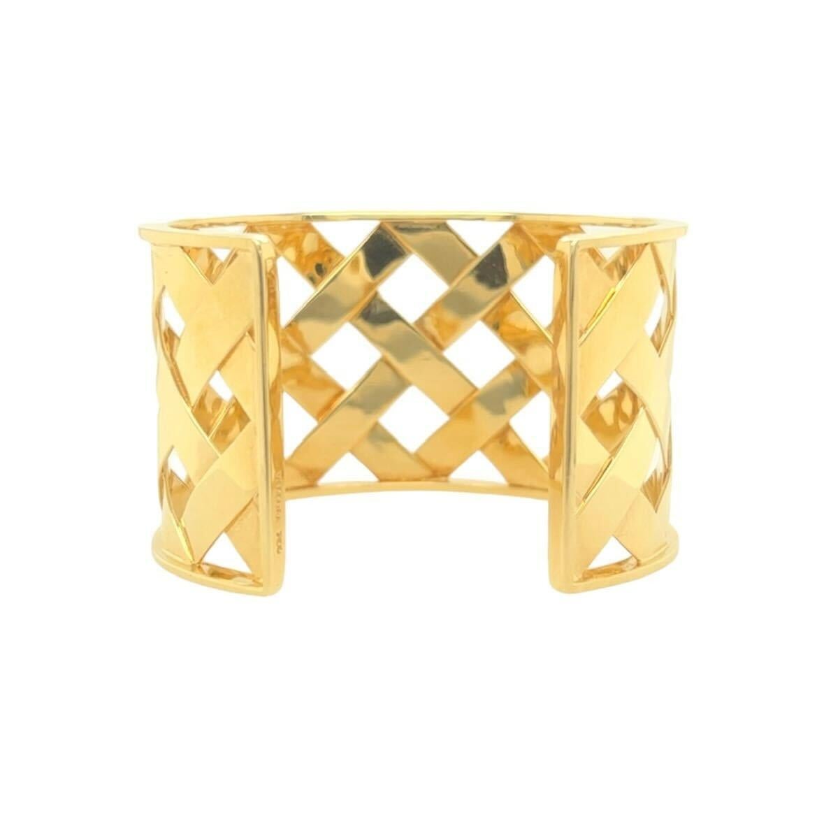 An 18 karat yellow gold bracelet, Verdura.  The “Criss Cross” cuff designed as a wide, open backed cuff of lattice woven gold.  Inner circumference approximately 6 1/4 inches.  Gross weight approximately 66.30 grams.  Signed Verdura and hand