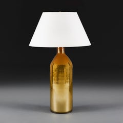 A Gold Verre Eglomise Glass Torpedo Table Lamp