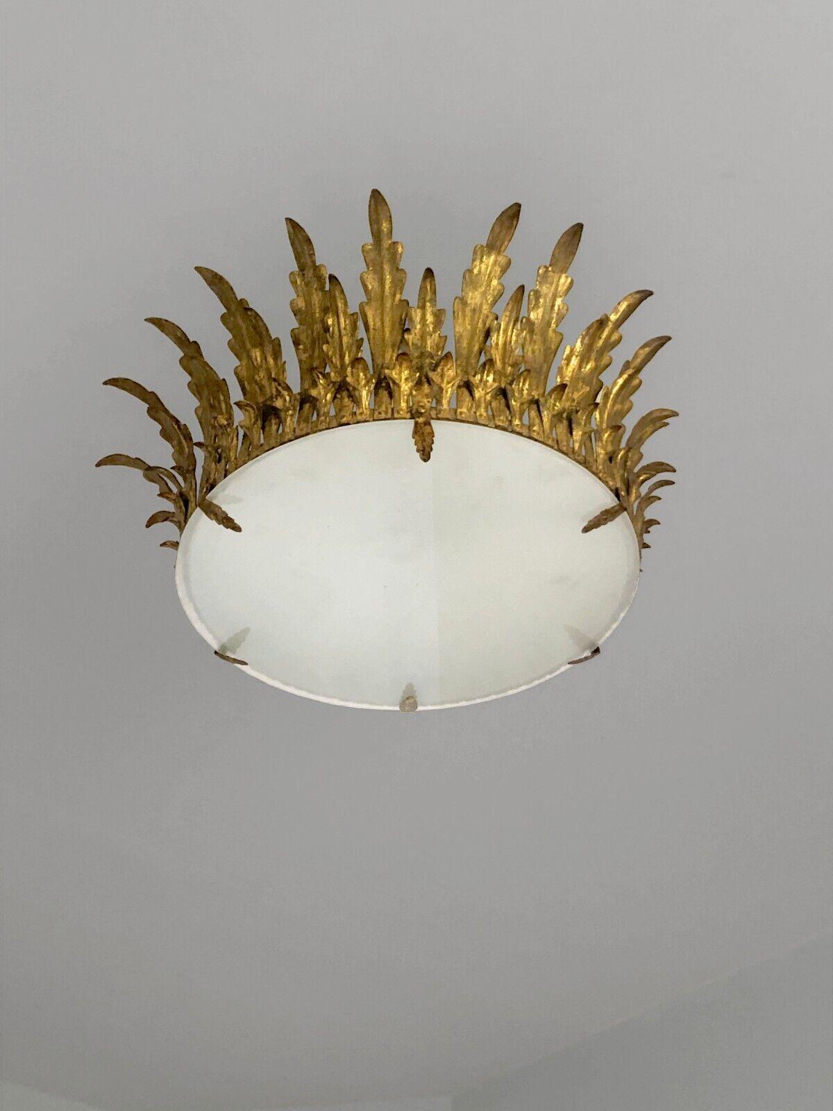 An elegant suspension, chandelier, ceiling light, circular in crown or sun, Art-Deco, Neo-Classical, Shabby-Chic, circular assembly of folded leaves in patinated golden brass forming a small crown, circular diffuser in sandblasted glass, Maison