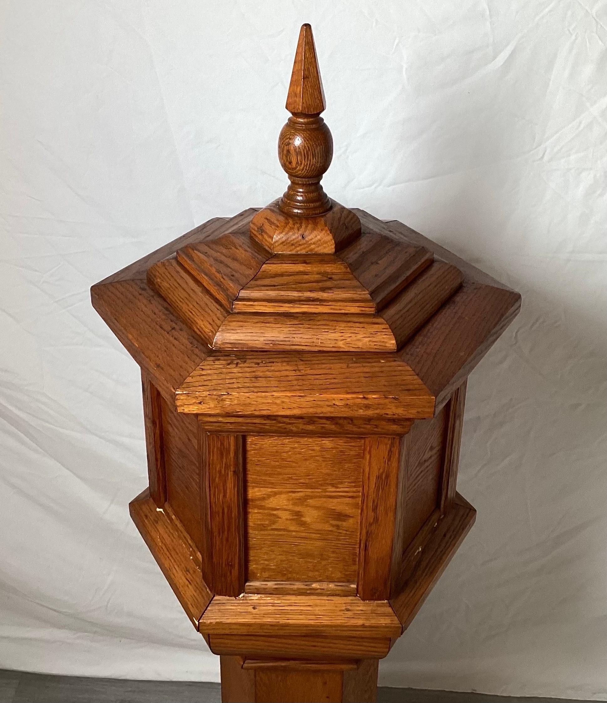 A six sided hand made quarter sawn oak jardinière with copper liner, originally thought to be a baptismal stand, Signed under base and dated 1939, 47 inches tall, 15 by 15 inches.