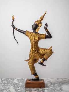 A golden statuette of a Thai dancer