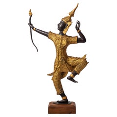 A golden statuette of a Thai dancer