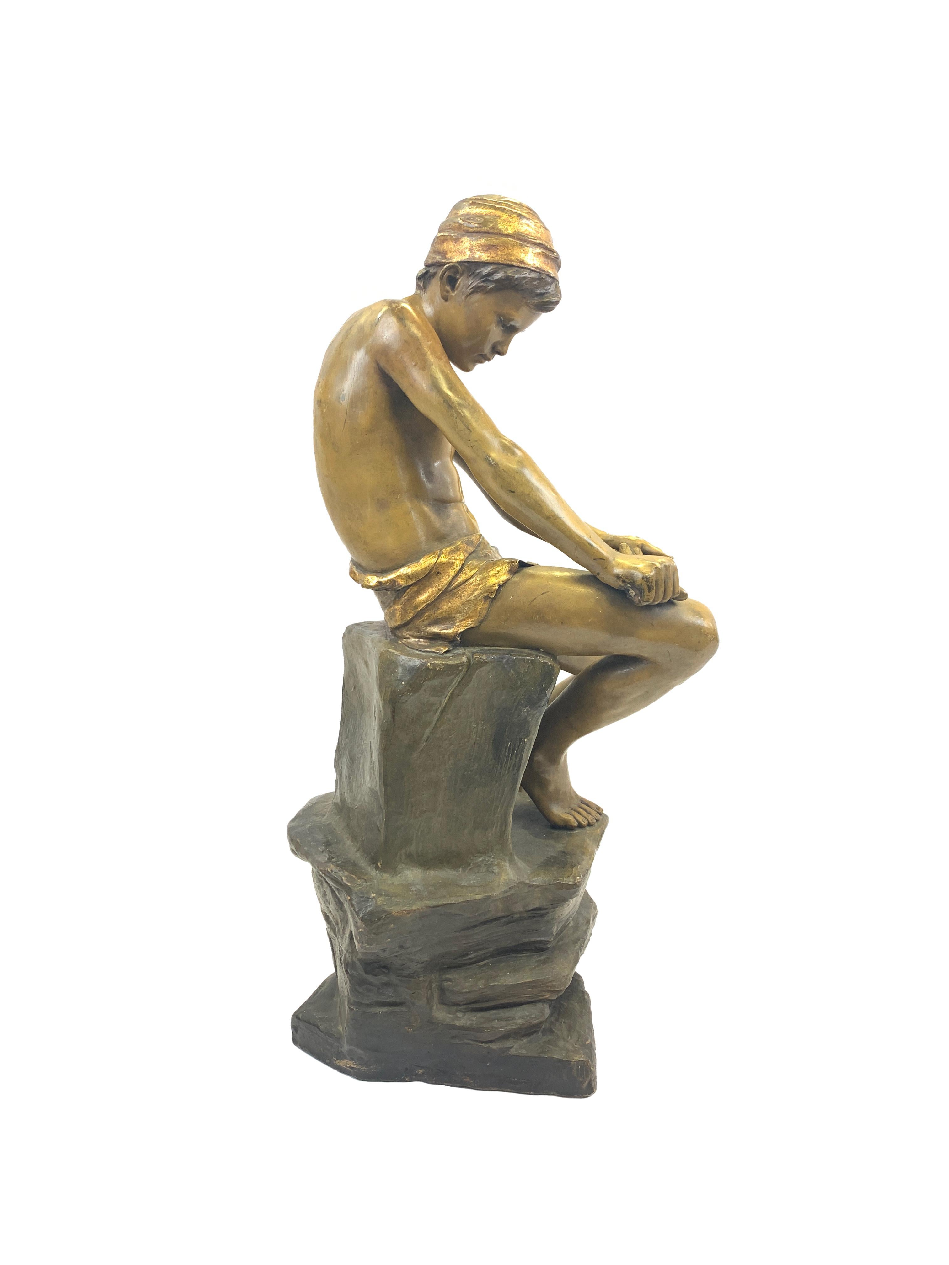 The action and intense concentration of the young boy almost make us forget he is made of terracotta! This piece bears be Friedrich Goldscheider mark, as well as a signature. (1845-1897).
 