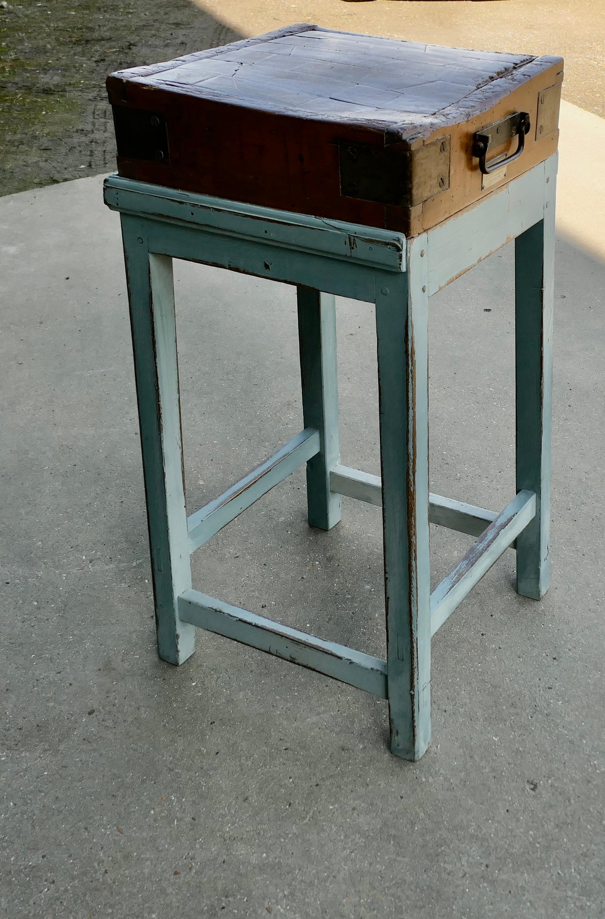 A Good French Butcher’s Block  from  Dubec

This is an antique Sycamore Chopping Block with tall square painted legs, the 5” thick chopping block has a sturdy painted base, the block itself has reinforced metal corners and a crying hands beneath the