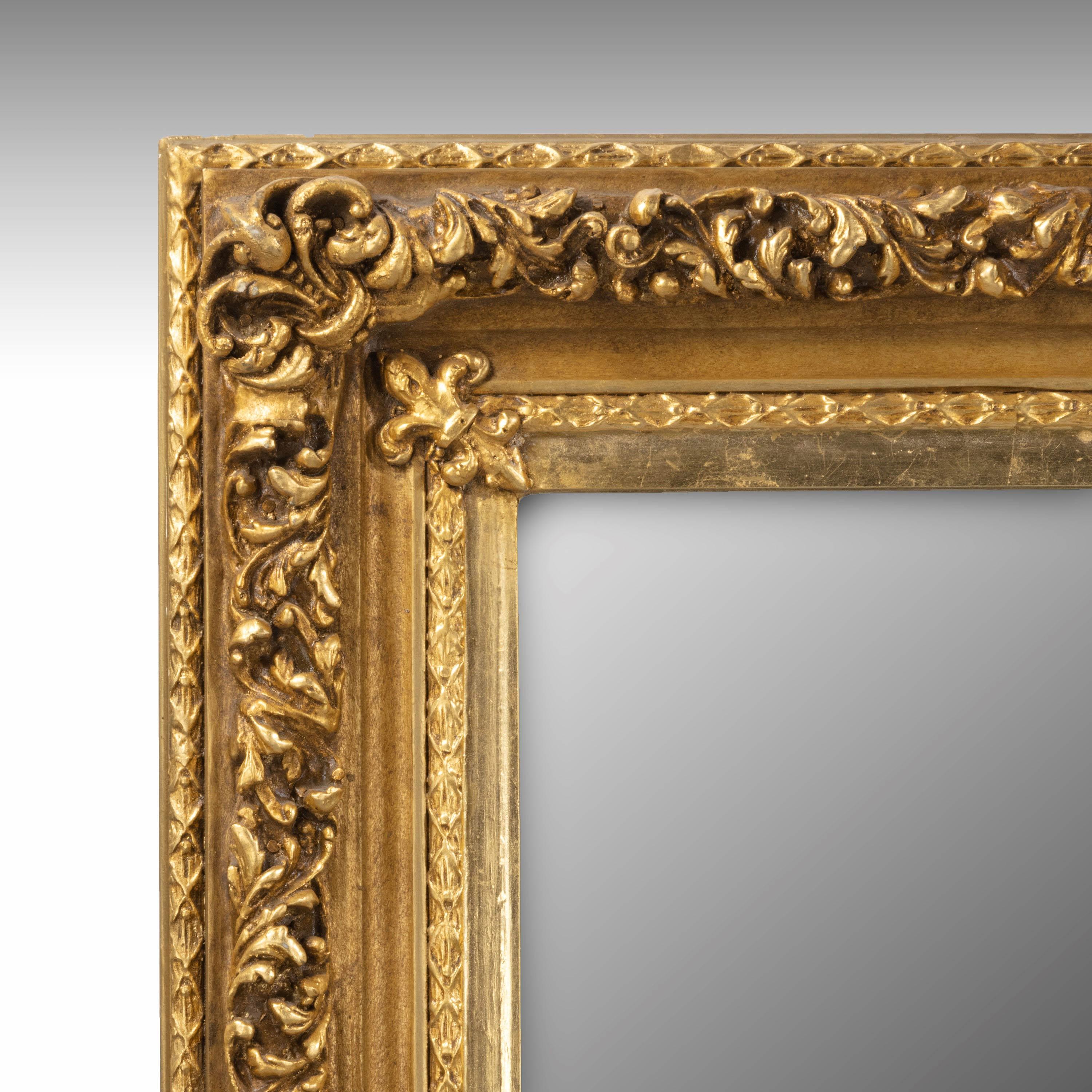 A good quality, large, rectangular mirror with a good bevelled plate. Capable of being hung portrait or landscape. Double carved border retaining the original gilding. Now gently oxidised and most attractive.
         