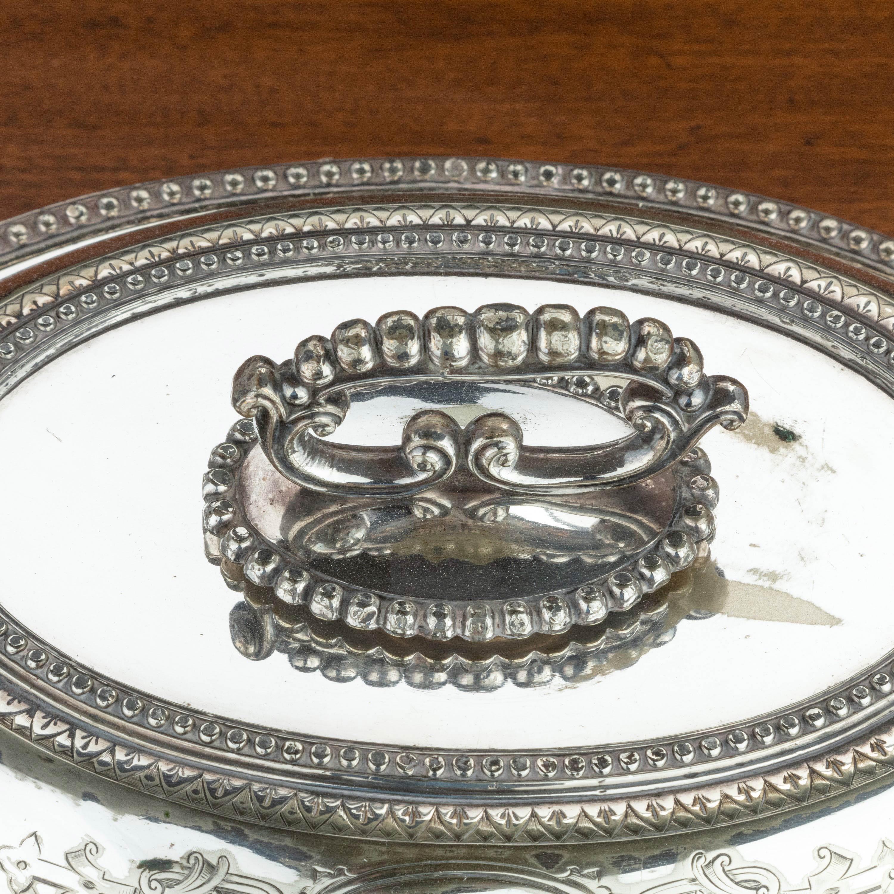 A good EPNS silver plated oval entrée dish. With finely cast borders and a Grecian key border to the lid. The handles can be removed to give two separate dishes. On French feet. Showing slight wear as the plating is completely original.