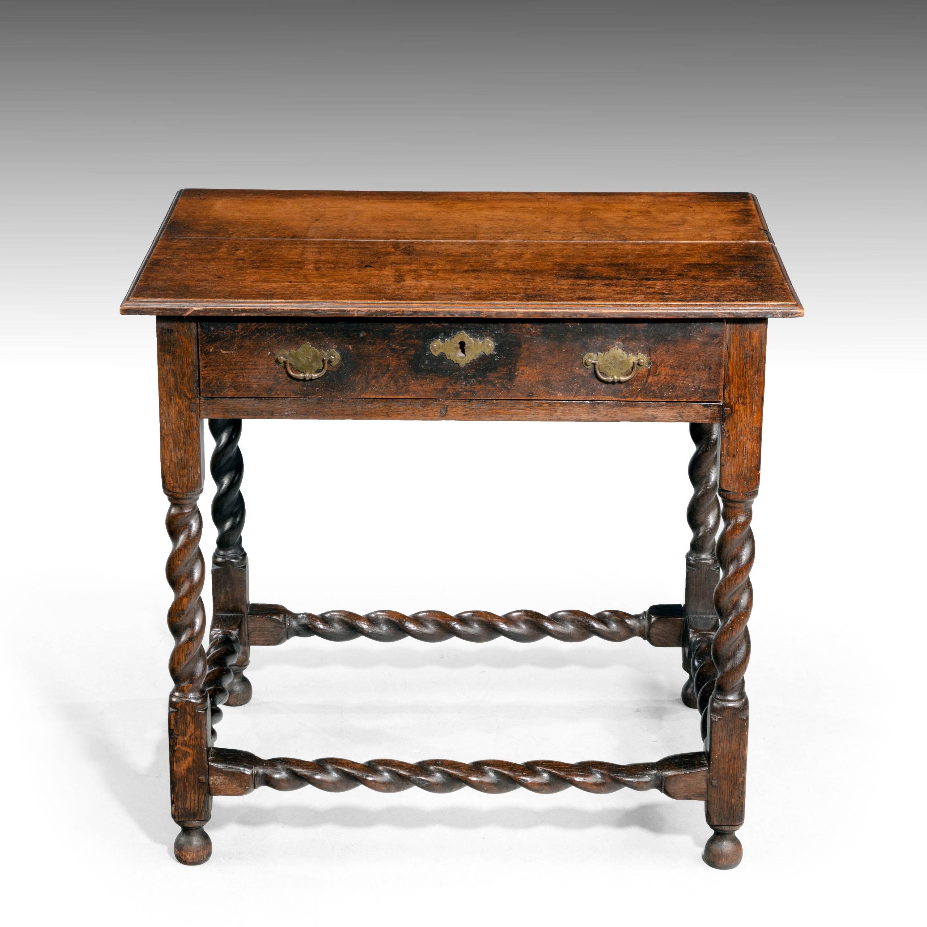 A good late 17th century oak side table with a single drawer. Finely turned writhen supports with writhen cross stretchers. Replaced period winged handles.
  
