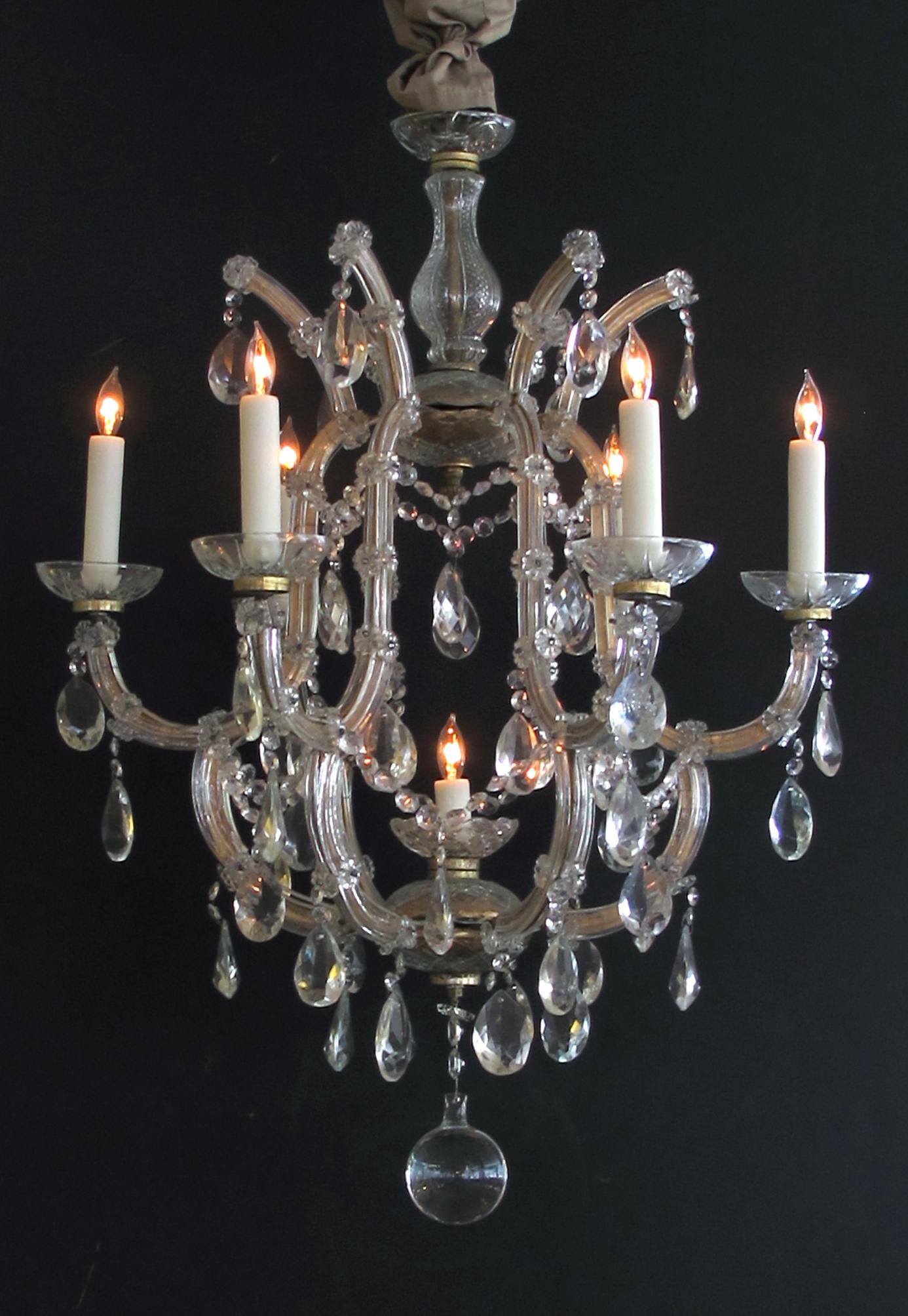 A good pair of continental Maria Theresa basket-form glass and crystal 6-light chandeliers; possibly Viennese; these elegant chandeliers composed of hand-forged gilt-metal frames sheathed in glass; emanating 6 scrolled candlearms with a central