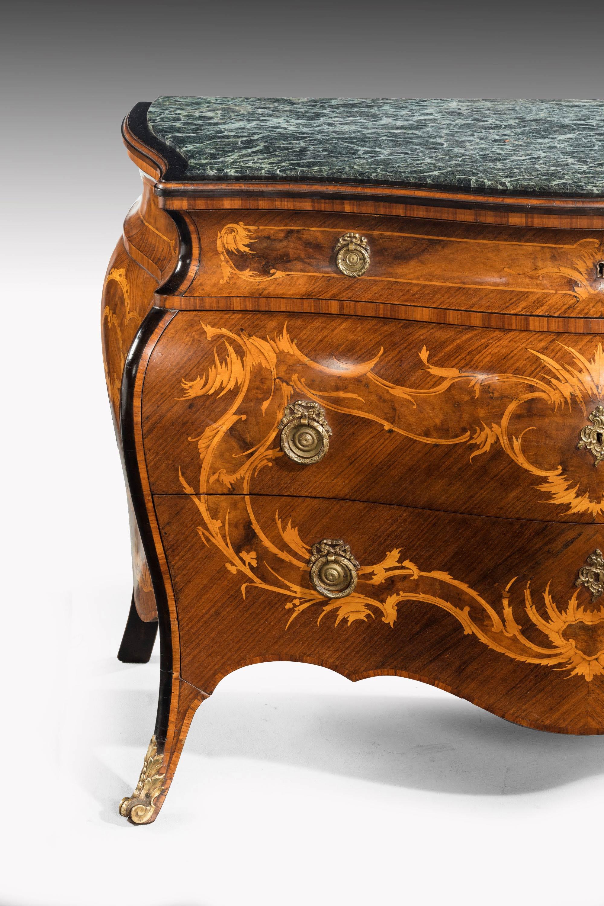A good pair of Northern European continental walnut parquetry and marquetry commodes in the 18th century style. Each retaining a marble top inset and above three drawers with figured marquetry inlay. Attractively patinated and with the original