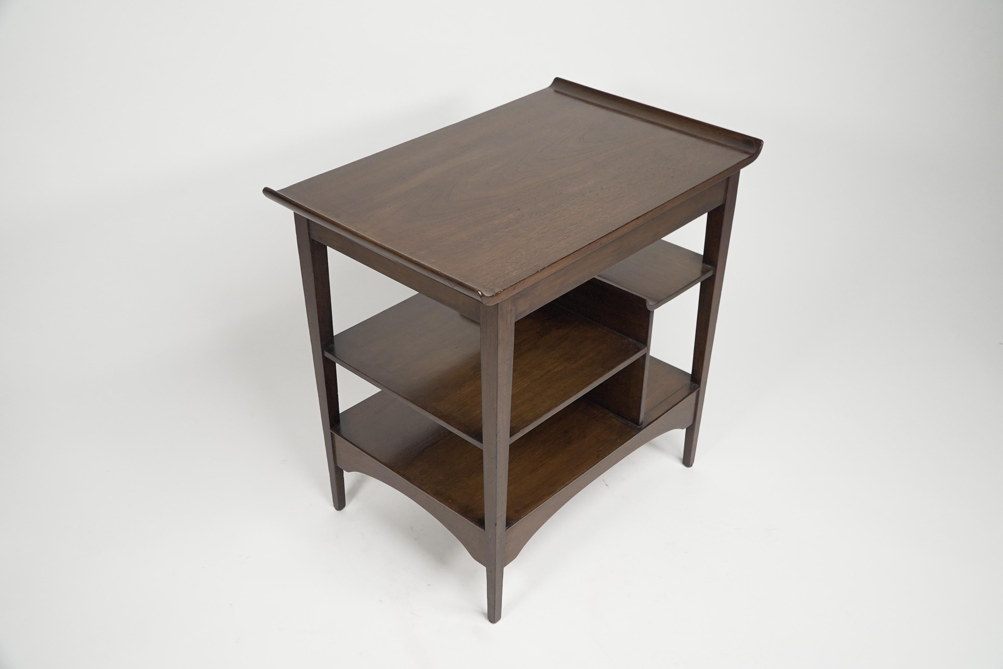 A good quality Aesthetic Anglo-Japanese Walnut side table with Torii gate style curving uprights to the top and to the upper shelf end, with an asymmetrical arrangement of shelves on square tapering legs.