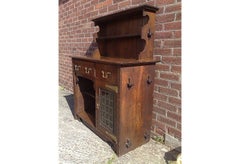 A good quality Arts and Crafts small oak sideboard/dresser