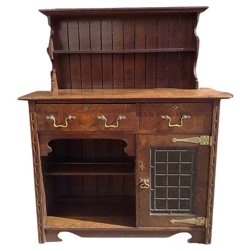A good quality Arts and Crafts small oak sideboard/dresser