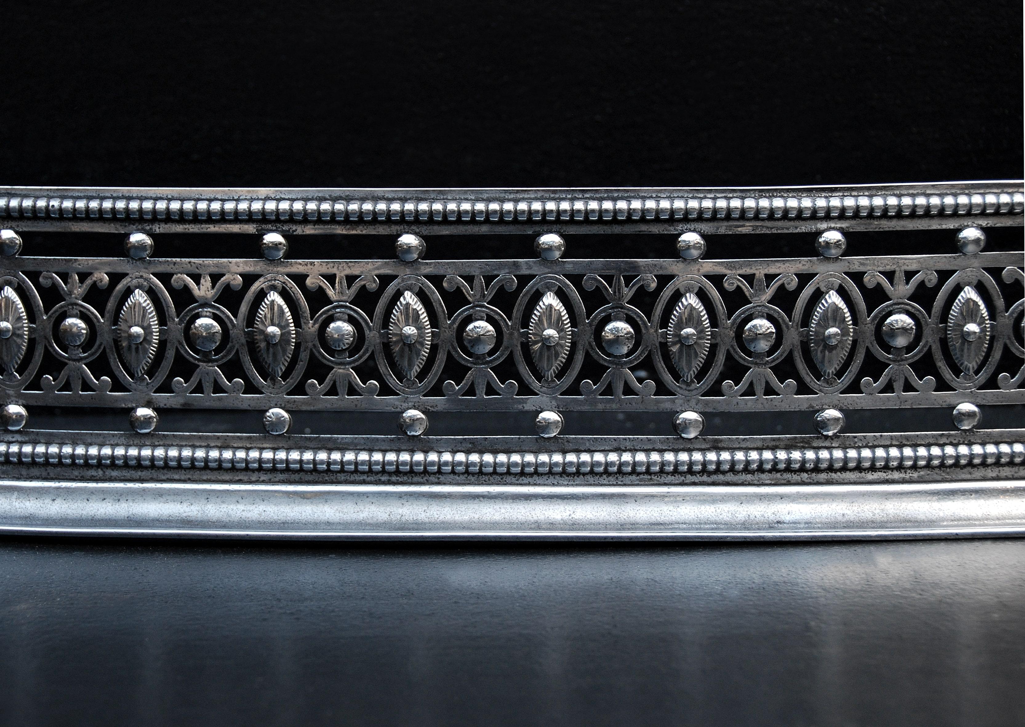 A fine quality English steel fender. The pierced fret featuring oval pateras with beading above and below. Late 18th century.

Measures: External Width: 1390 mm 54 ¾