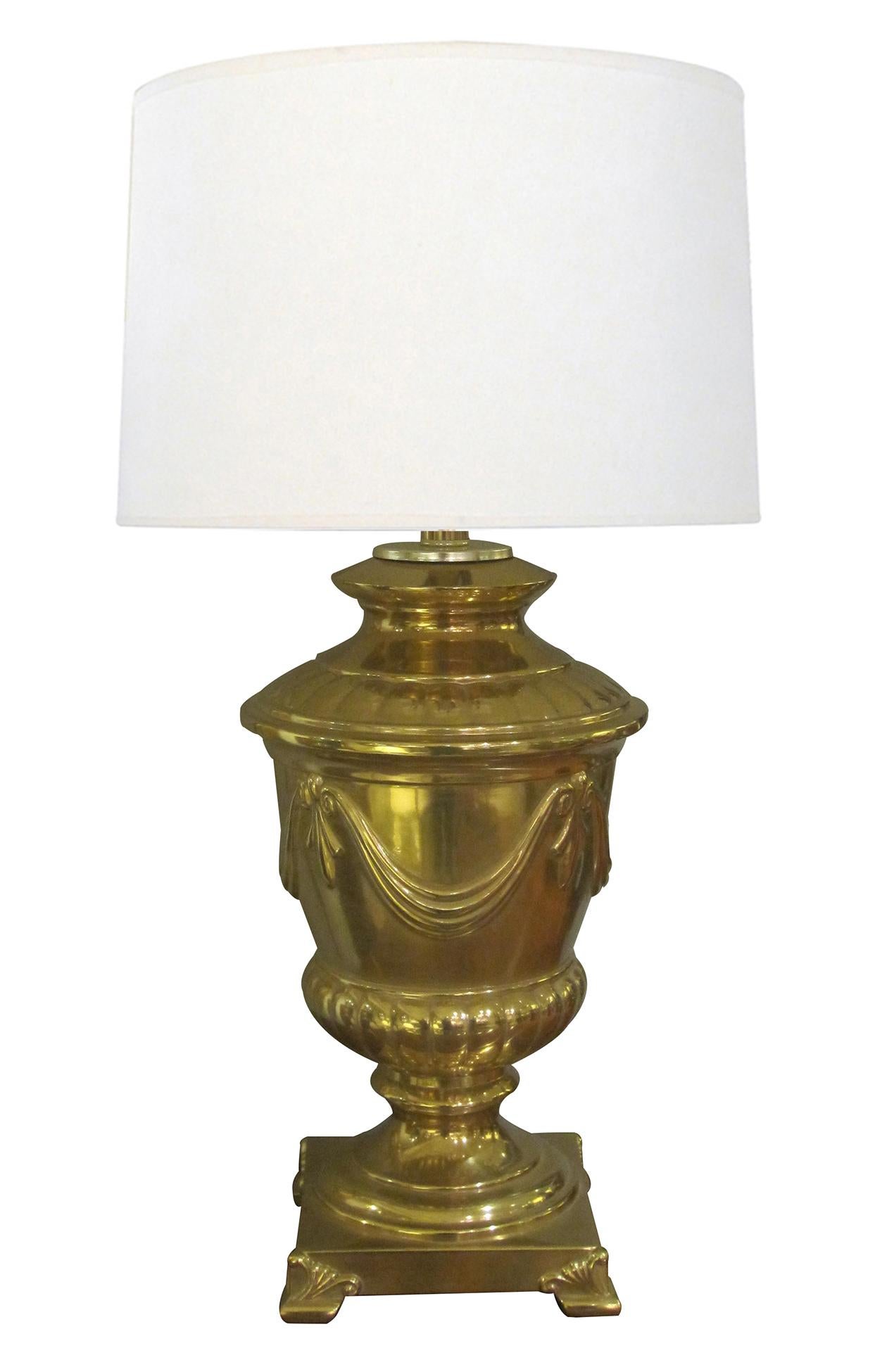 each heavy lamp of neoclassical campagna form adorned with draped swags all raised on anthemion feet