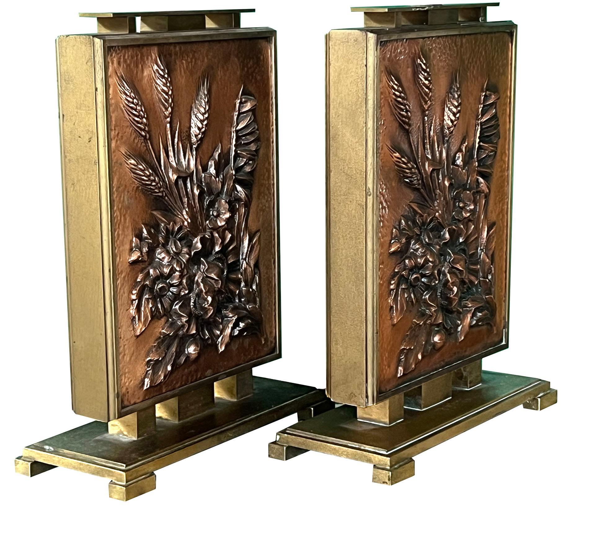 each with exceptional copper repoussé plates depicting a finely-detailed bouquet of flowers, foliage and wheat sheaths (repeated on the back) all within a heavy bronze frame over a stepped plinth; Albert Louis Gilles was born in August of 1895 in