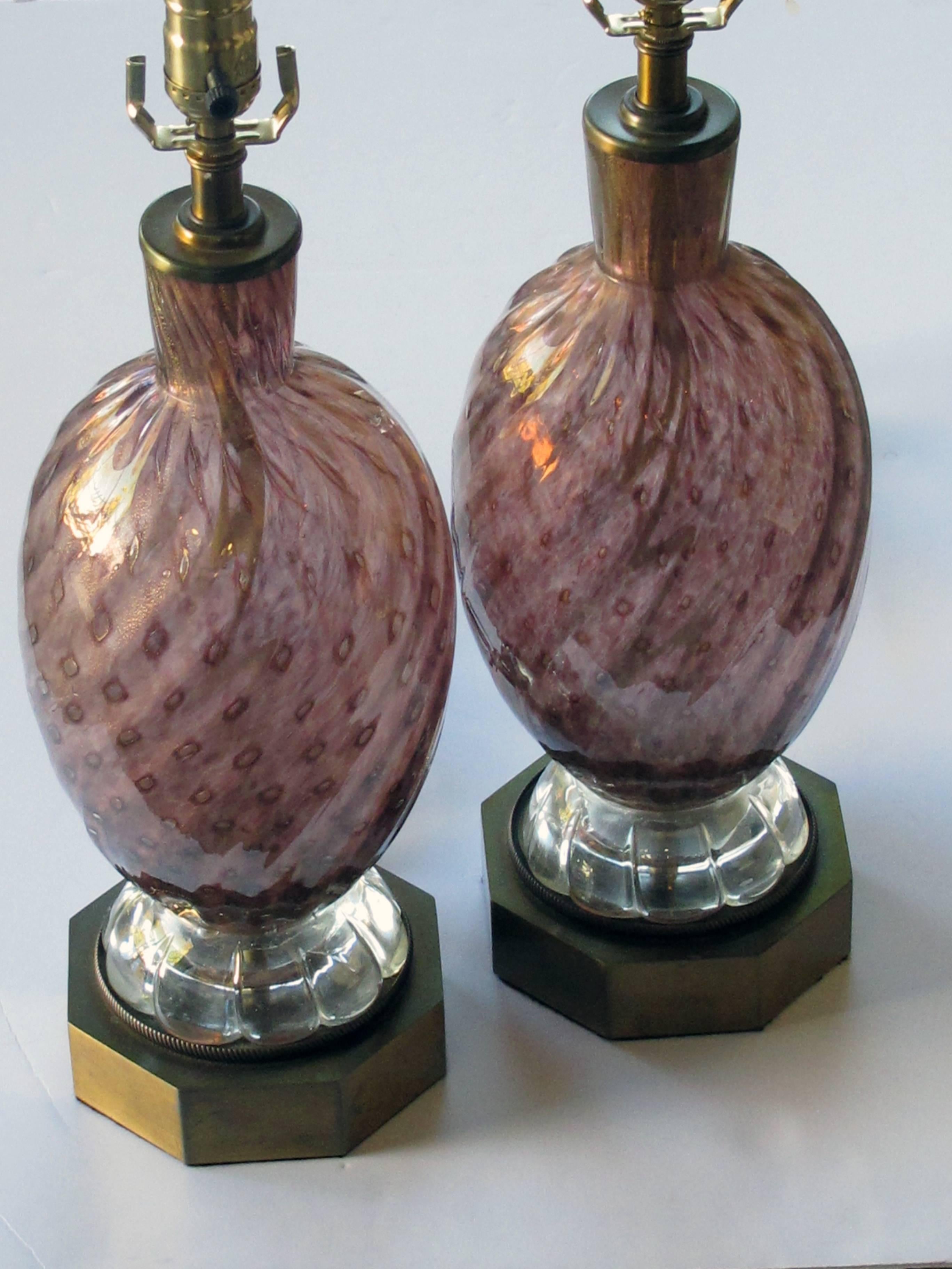 Each striking lamp of deep purple bullicante and gold aventurine glass with an iridescent surface; raised on a brass octagonal base.