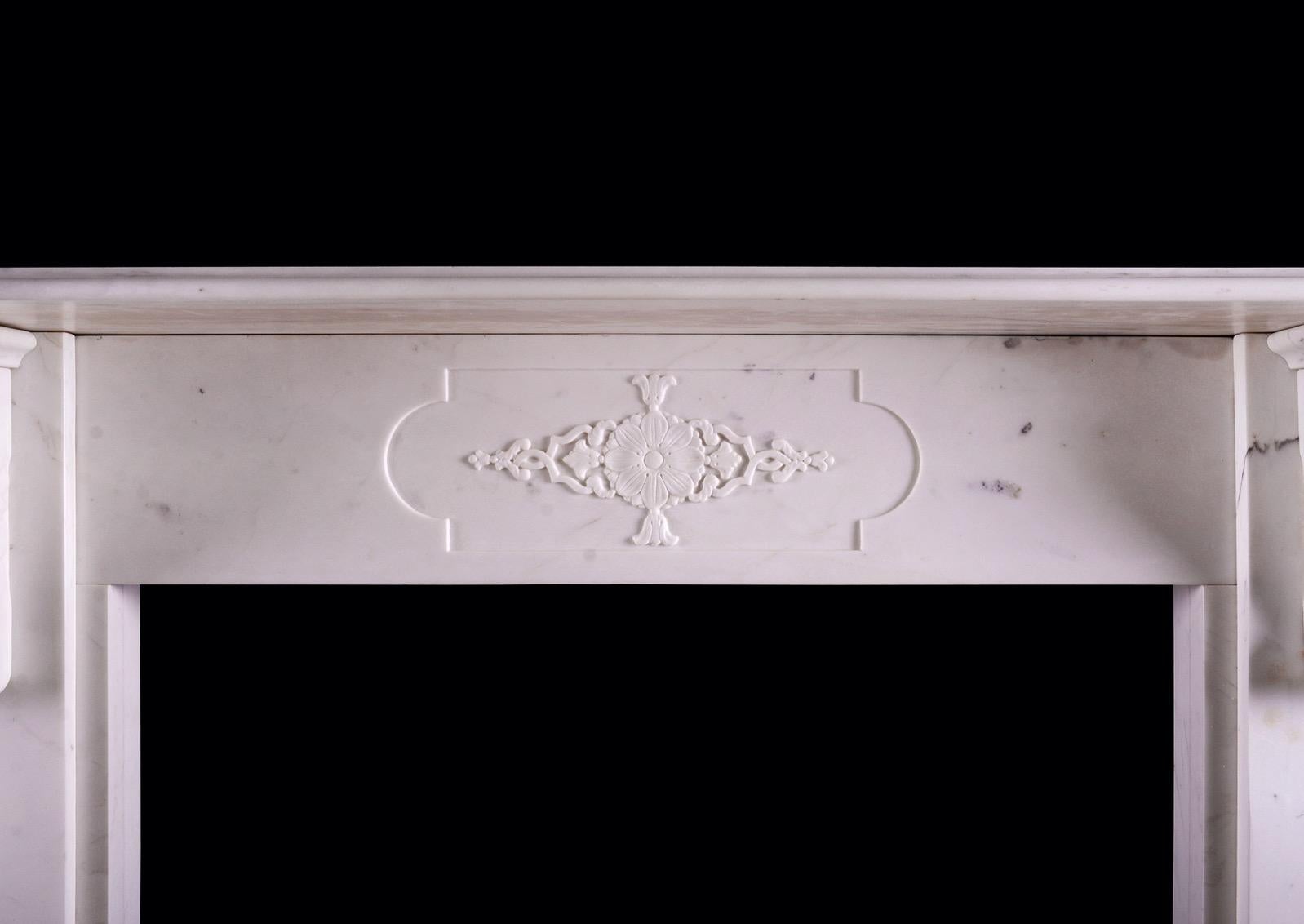 A good quality period Victorian fireplace in Statuary white marble. The jambs with corbels featuring acanthus leaves with decorative panels below. The frieze with centre panel carved with rosette and bellflower detailing. Moulded shelf above.