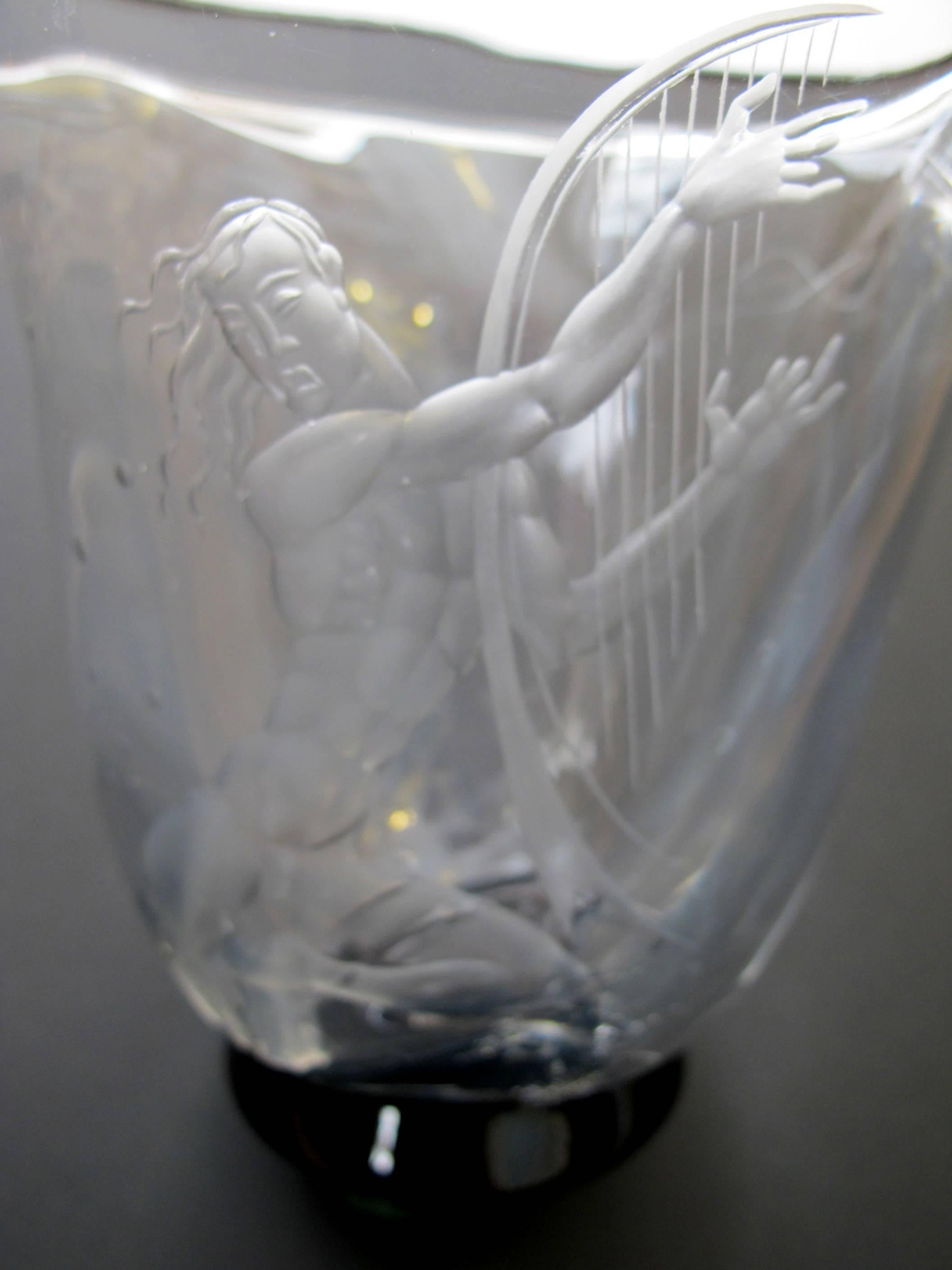 A good quality Swedish Art Deco etched glass vase of an undersea harp player possible Apollo; form by Simon Gate, decoration by Vicke Linstrand for Orrefors; signed; the square form flared opening above a slightly bulbous body carved in opaque with