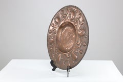 A good quality well executed Arts and Crafts copper wall plate