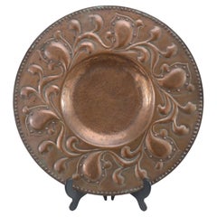 A good quality well executed Arts and Crafts copper wall plate