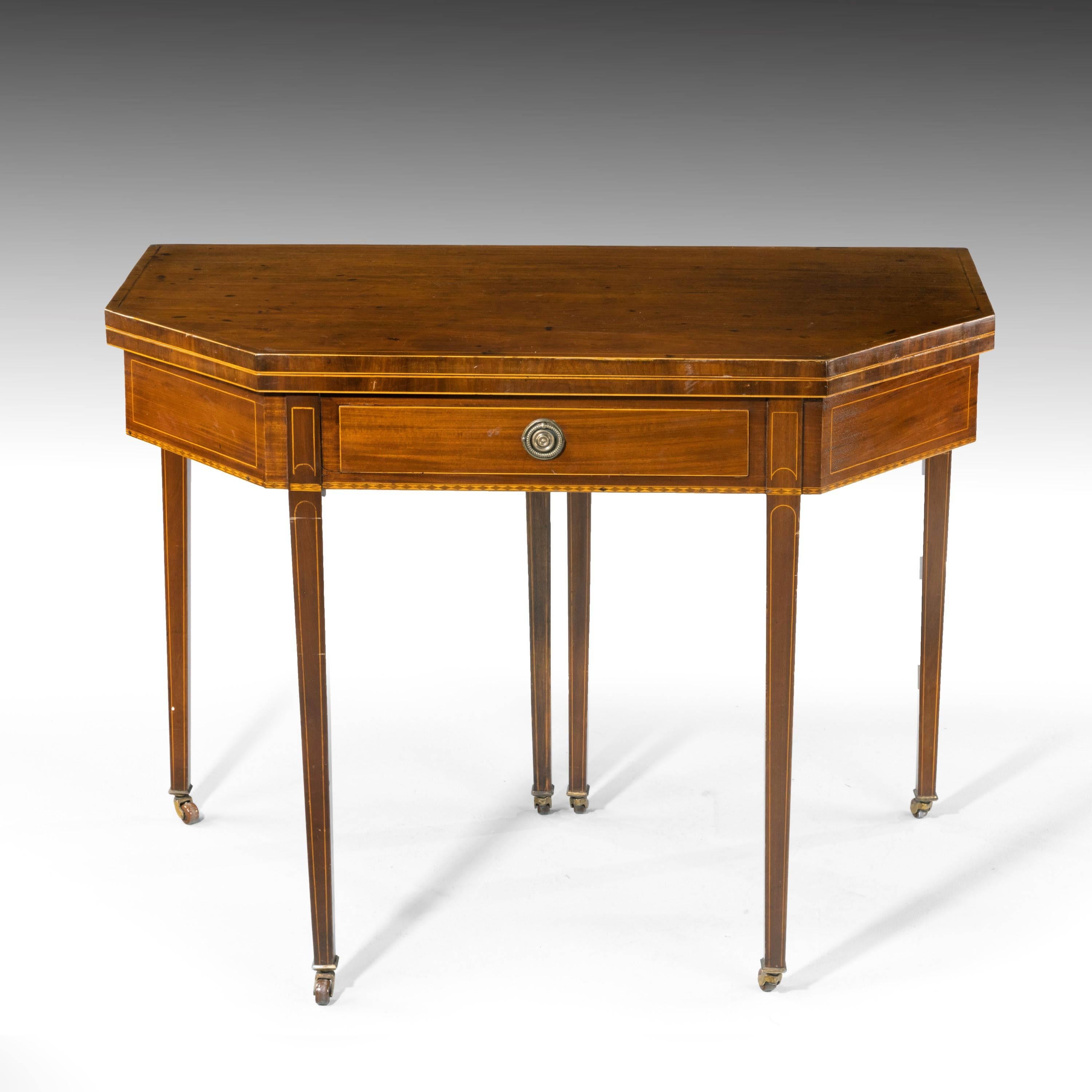 A good Sheraton period mahogany tea table. With strongly canted corners. The whole of the top crossbanded with satinwood edging. The bottom edge of the carcass with the most attractive chequered detail. Single drawer to the centre section with the