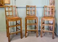 A Good Trio of Arts and Crafts High Bar Stools, in Leather and Golden Oak