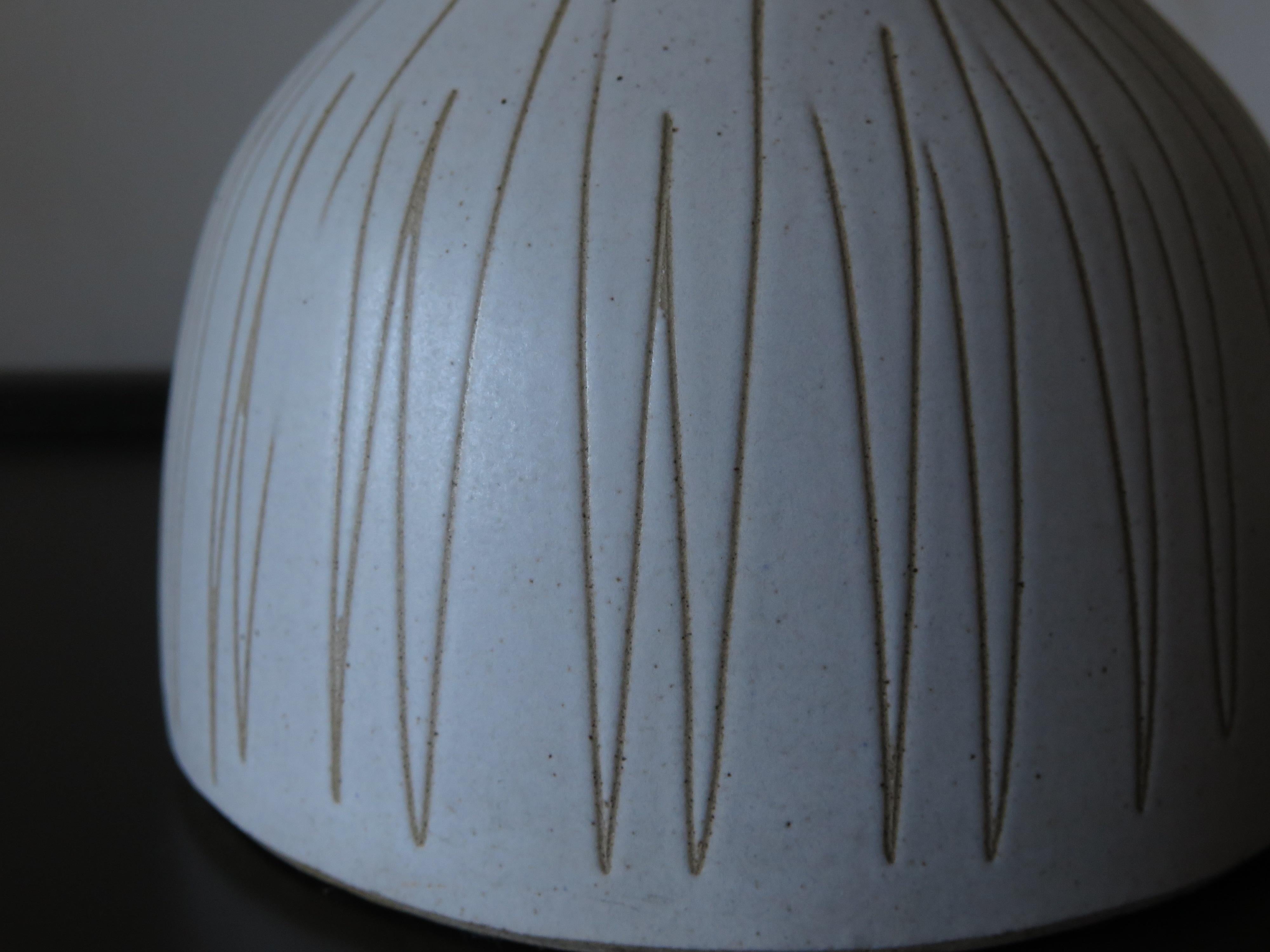 A beautiful Martz lamp ca' 1960's in off white with sgraffito decoration. Original shade/finial.