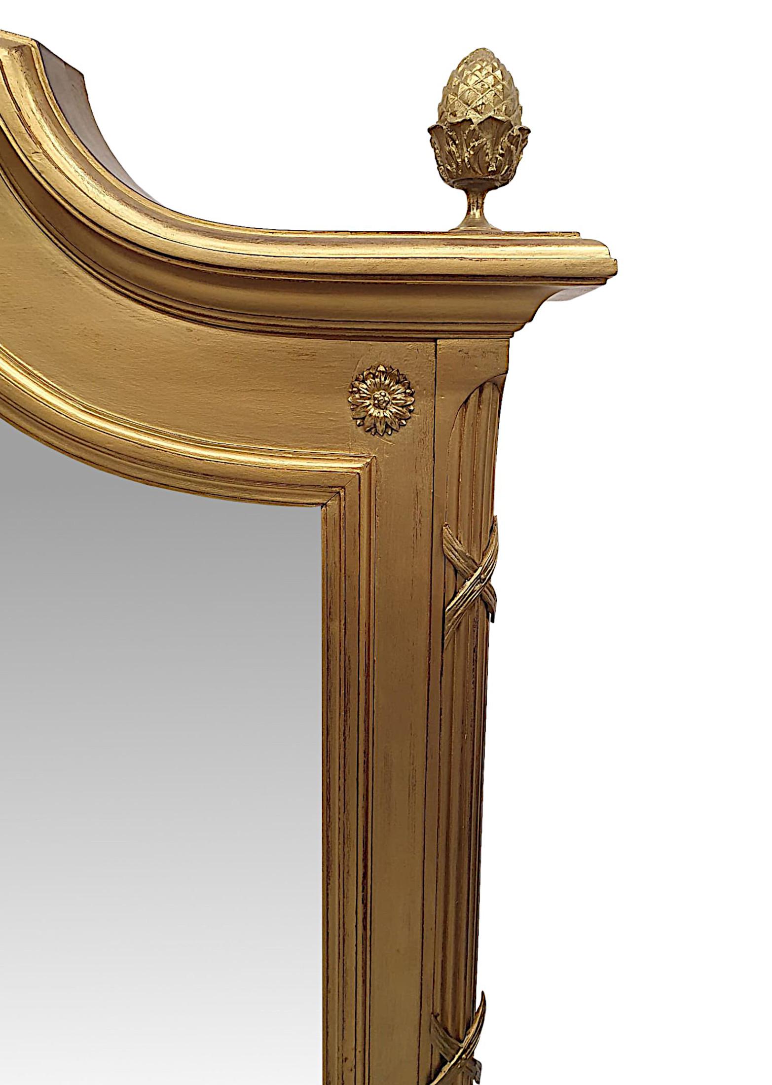 A gorgeous 19th century brass mounted giltwood overmantle mirror, The bevelled mirror glass plate of shaped, rectangular form is set within a stunningly hand carved, moulded giltwood frame with canted, reeded sides with ribbon detail, the frieze