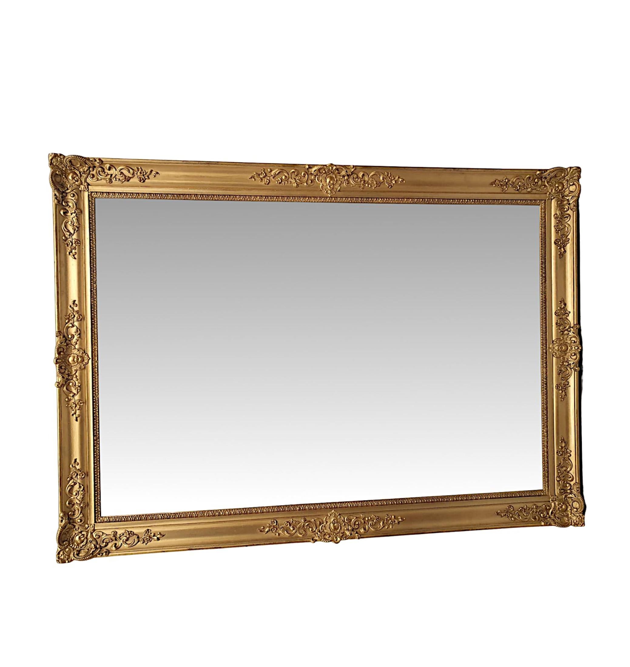 A gorgeous 19th century giltwood overmantle mirror. The mirror glass plate of rectangular form is set within a finely hand carved, moulded and fluted giltwood frame with a beautiful lambs tongue border and with fabulously detailed and elegant motifs